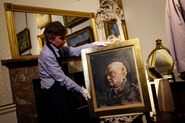 Matthew Floris, a Sotheby's employee poses with a portrait, a surviving study of Winston Churchill in the bedroom where Churchill was born at Blenheim Palace, north of Oxford, home to the Duke of Marlborough and Churchill's family home, on April 16, 2024. The celebration of Churchill's 80th birthday was a remarkable event, and he received 150,000 presents from all over the world. For their gift, Britain's Houses of Parliament proposed a painting by English artist Graham Sutherland. Within two years, such was the rancour with which the painting was viewed, Churchill arranged for it to be taken away and destroyed. The study, made for the destroyed painting, was estimated to realise between five and eight hundred thousand GBP pounds at a Sotheby's auction on June 6.