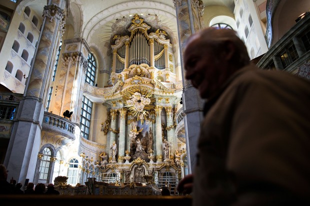 DRESDEN, GERMANY - FEBRUARY 13: Visitors look at the Frauenkirche before the commemoration of the 70th anniversary of the Allied firebombing of Dresden on February 13, 2015 in Dresden, Germany. On February 13-14, 1945, U.S. and British bombers attacked in successive raids that devastated the city and killed at least 25,000 people. The formation of a human chain has become an annual occurrence that not only commemorates the bombing but also makes a statement against local neo-Nazis, who in years passed have sought to use the anniversary to their own ends. 