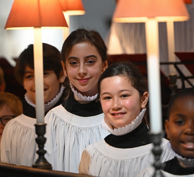 Girl choristers eleven-year-old Lila (2L), and ten-year-old Lois, pose for photographers during a photocall at St Paul's Cathedral in London on June 29, 2024. Girl choristers formally join the St Pauls Cathedral Choir as full choristers for the first time in its 900 year history. 